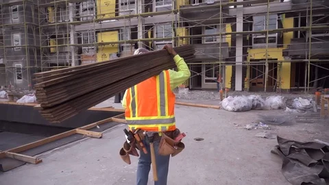 Construction worker working on a construction site wearing a tool belt. Stock Footage 100342313