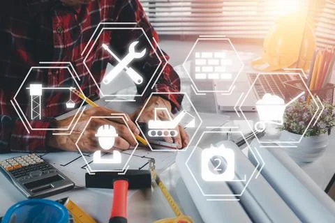 Construction worker working in office with engineering tools with VR screen.. Stock Photos