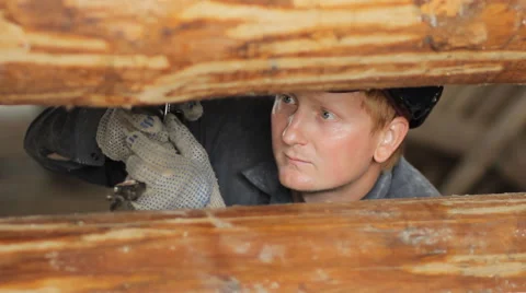 Construction worker is working with wooden beam Video stock 65414466