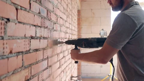 A construction worker works with a puncher close up. Stock Footage 160888166