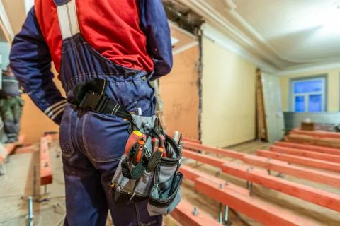 Construction worker with workwear and tool baf with tools on the waist  i Stock Photos