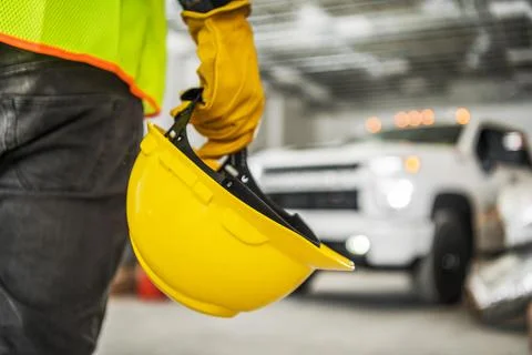 Construction Worker with Yellow Hard Hat in His Hand 库存照片