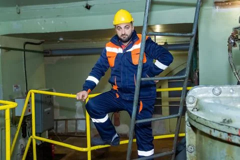 Construction worker with yellow helmet in factory Stock Photos