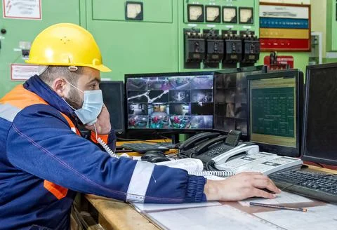 Construction worker with yellow helmet in factory Stock Photos