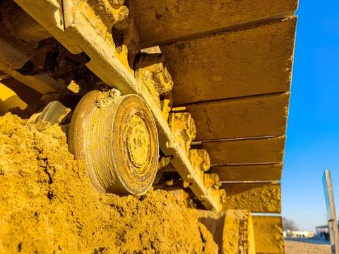 Construction worker in a yellow helmet working on building site Stock Photos