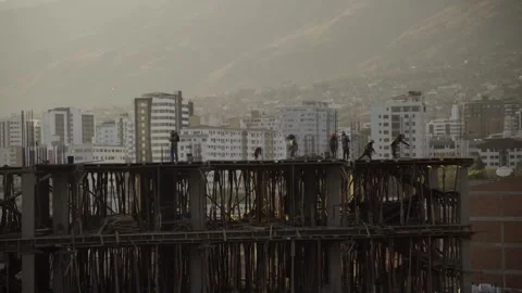 Construction Workers Active on Concrete Slab Above Wooden Formwork 動画素材 310406445