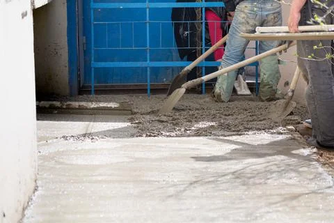 Construction workers aligns concrete screed. Construction, Foundation, Screed Stock Photos