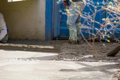 Construction workers aligns concrete screed. Construction, Foundation, Screed Stock Photos