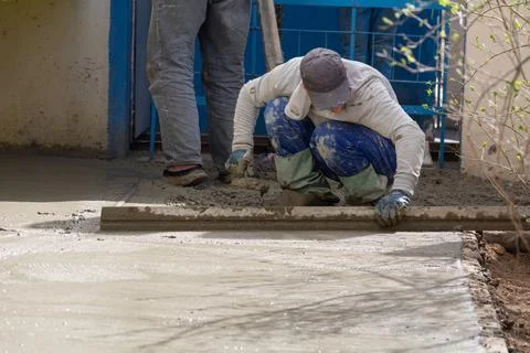 Construction workers aligns concrete screed. Construction, Foundation, Screed Stock Photos