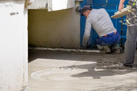 Construction workers aligns concrete screed. Construction, Foundation, Screed Stock Photos