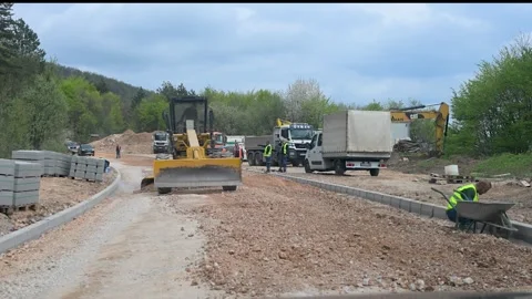 Construction workers and excavators preparing road for asphalt paving. Stock Footage 335026171