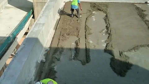 Construction Workers Applying Floor Screed Gradient on Flat Roof Slab Stock Footage 336645635