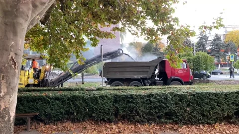 Construction workers are changing asphalt on the road. Stock Footage 223943943