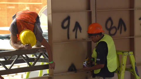 Construction workers are installing plywood wall Stock Footage 132443565