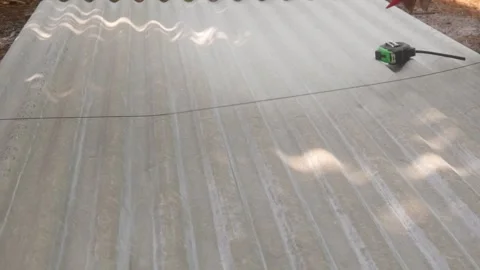 Construction workers are marking cutting lines on corrugated asbestos Stock Footage 333348490