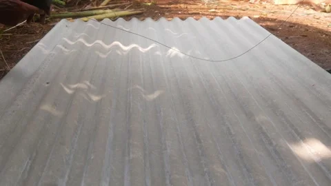 Construction workers are marking cutting lines on corrugated asbestos Stock Footage 333348493