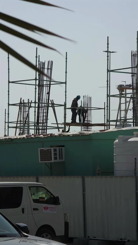 Construction workers are seen working at a construction site in Dubai, United Stock Footage 328580489