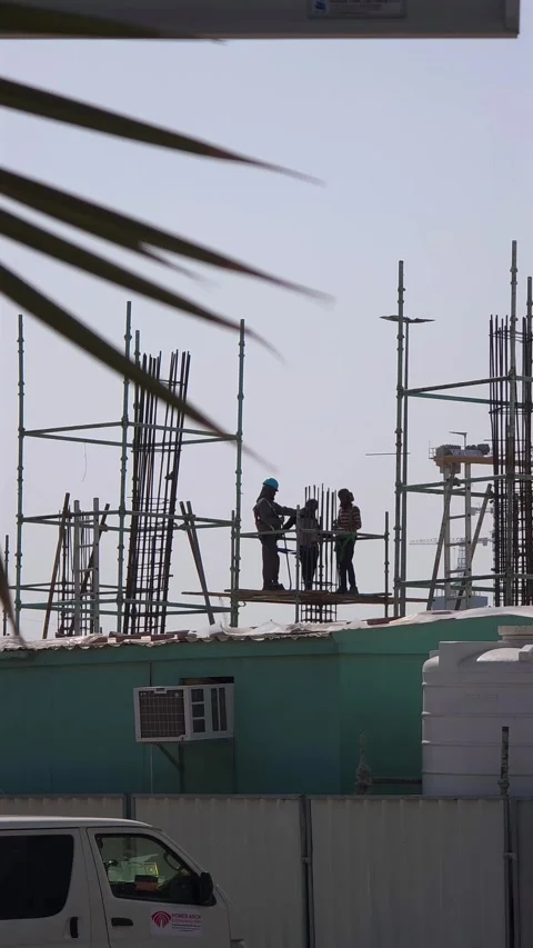 Construction workers are seen working at a construction site in Dubai, United Stock Footage 328580694