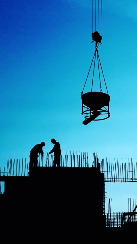 Construction Workers Are Silhouetted Against a Beautiful Blue Sky in the Stock Footage 290191907