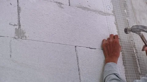 Construction workers are trying to hammer nails and steel plates to secure .. Stock Footage 300075288