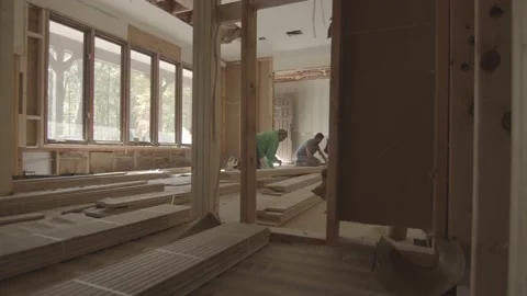 Construction workers begin to lay hardwood floors Stock Footage 144294793