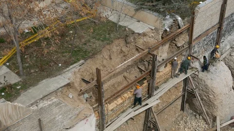 Construction workers build brick wall at height in a dangerous unsafe way Stock Footage 96131434