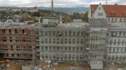 Construction workers build a house shooting from the air 스톡 동영상 121727666