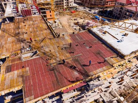 Construction workers build a large structure on a busy construction site wi.. Stock Photos
