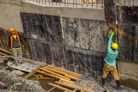 Construction workers build mini hydroelectric power plant Foto stock