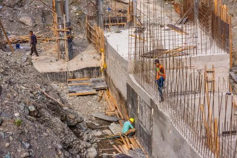 Construction workers build mini hydroelectric power plant Stock-Fotos