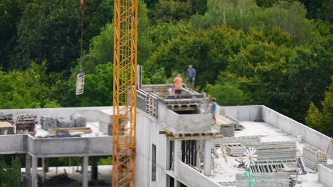 Construction workers build a modern concrete building. Stock Footage 346656411