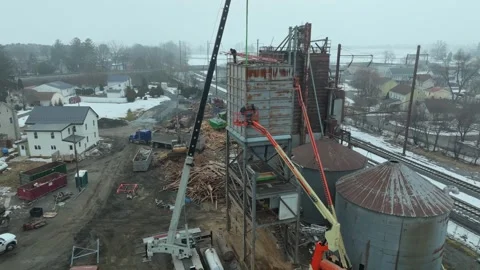 Construction Workers Build a New Structure Near Homes in a Rural Area Durin.. Stock Footage 331955693