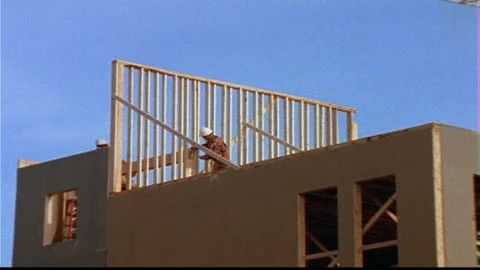 Construction workers build wall -Crane behind Video stock 145617798