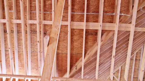 Construction workers build wooden beams frame inside new house in residential Stock Footage 342664236