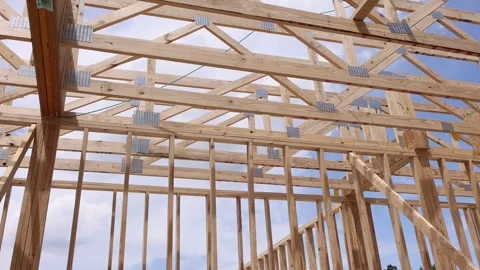 Construction workers build wooden framework for house in an outdoor setting Video stock 337740268