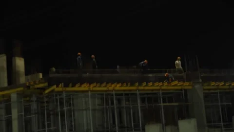 Construction workers building a concrete structure at night with helmets. Stock Footage 342371137