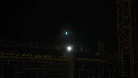 Construction workers building concrete structure at night with bright lights. Stock Footage 342371838