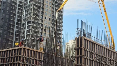 Construction workers building concrete structures with metal reinforcement Stock Footage 297614331
