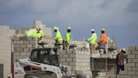 Construction Workers Building House Tractor Passing Video stock 200798151