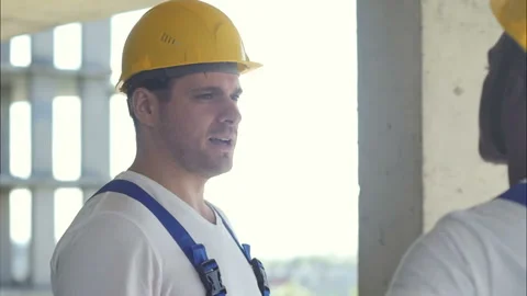Construction workers at building site talking Stock Footage 117139128