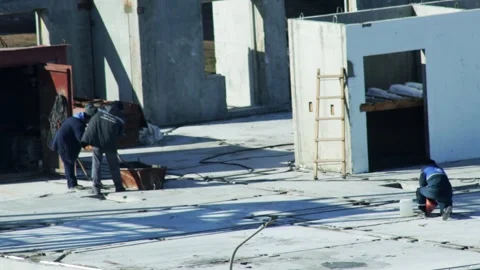 Construction workers busy on concrete slab foundation of building under 스톡 동영상 347580551