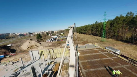 Construction workers carefully pouring concrete on wide bridge deck, operating Video stock 306397180