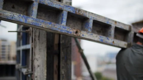 Construction workers carrying concrete formwork on site Stock Footage 323871244
