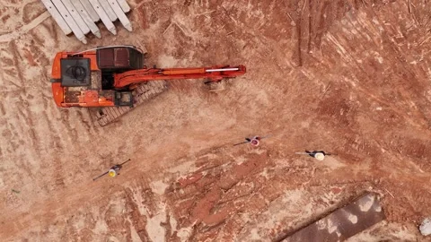 Construction Workers Carrying Metal Bars Near Excavator Vídeos de archivo 337623196