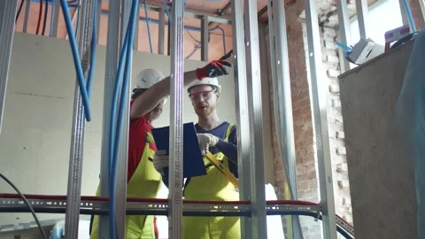 Construction workers check metal frame of future wall 動画素材 133639188