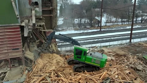 Construction Workers Clear Demolition Wood From a Site Near Train Tracks in.. Stock Footage 334257287