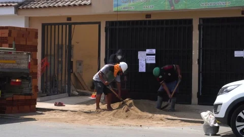 Construction workers collecting sand with dirt to climb a building with masks Stock Footage 148341579
