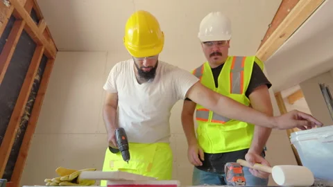 Construction Workers Coming Together to Collaborate on a Project While Wearing Stock Footage 306042268
