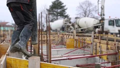 Construction workers with concrete boom pump pouring concrete into a formwork Video stock 303012656