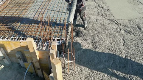 Construction workers with concrete boom pump pouring concrete into a formwork Stock Footage 306586561